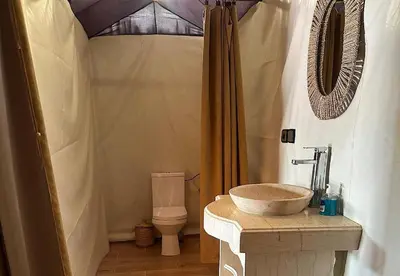 a bathroom with a sink and a toilet at Bein Merzouga Camp in Merzouga