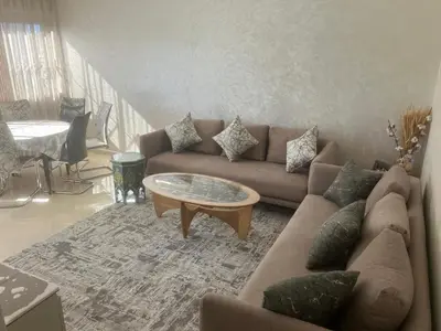 a living room with a couch and a coffee table at Baie D'AGADIR in Oulad Akkou