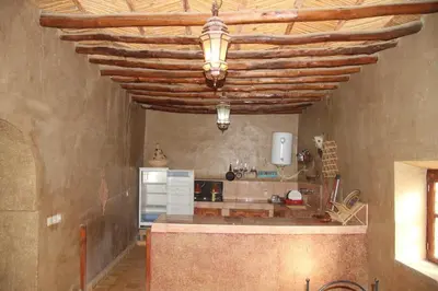 a kitchen with a wooden ceiling with a counter top at Sahara Apartament in Rissani