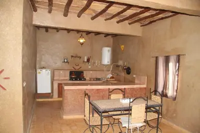 a kitchen with a table and a counter top at Sahara Apartament in Rissani