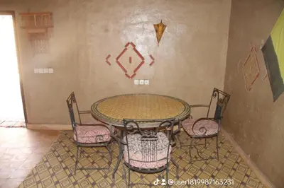 a table and four chairs in a room at Sahara Apartament in Rissani
