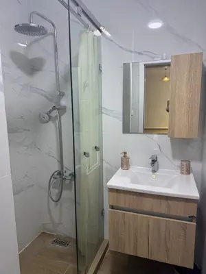 a bathroom with a sink and a shower at Exclusive Apartment for a Perfect Getaway in Fès