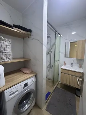 a washing machine in a bathroom with a shower at Exclusive Apartment for a Perfect Getaway in Fès