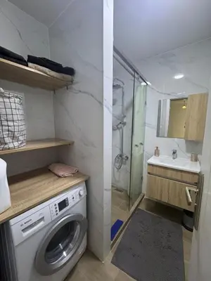 a small bathroom with a washing machine and a sink at Exclusive Apartment for a Perfect Getaway in Fès