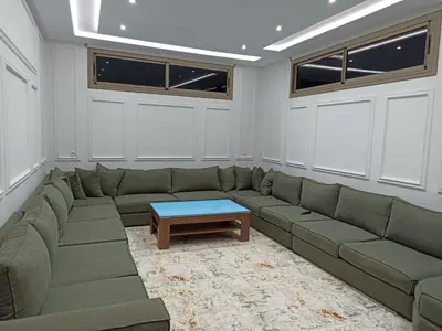 a living room with a green couch and a table at Villa de luxe avec jardin et parking privé in Beni Mellal