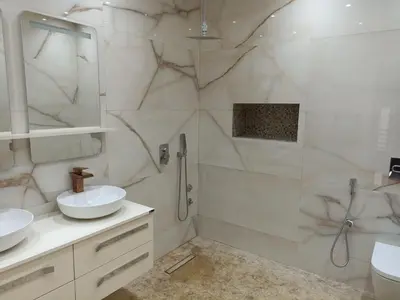 a white bathroom with a shower and a sink at Villa de luxe avec jardin et parking privé in Beni Mellal