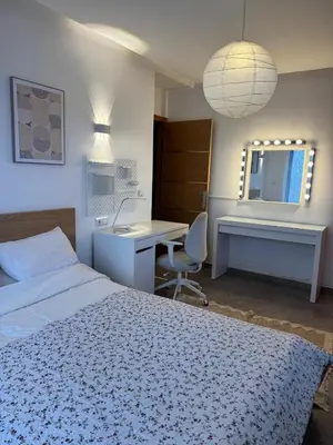 a bedroom with a bed and a desk and a mirror at Family Villa with Panoramic View of Infinite Horizon in Ifrane