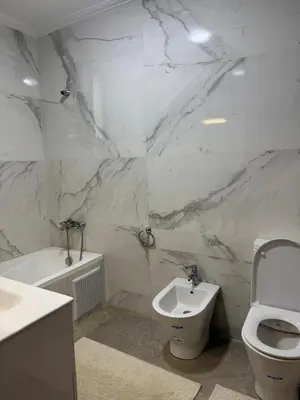 a bathroom with a toilet and a bidet and a sink at Family Villa with Panoramic View of Infinite Horizon in Ifrane
