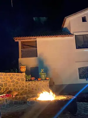 a fire pit in front of a house at night at Family Villa with Panoramic View of Infinite Horizon in Ifrane