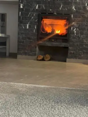 a brick fireplace with a fire in it at Family Villa with Panoramic View of Infinite Horizon in Ifrane