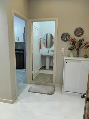 a bathroom with a sink and a mirror at well-equipped 2 bedroom apartment living room in Tiflet