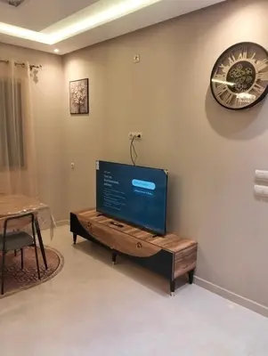 a living room with a flat screen tv on a wall at NEW Luxury & Equipped Dalia , 2 bedrooms living room in Tiflet