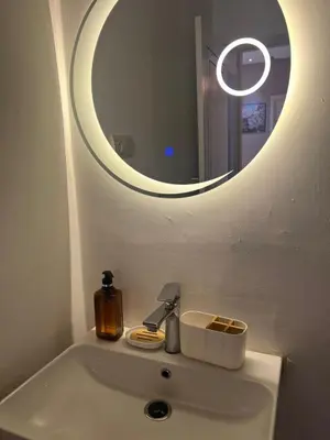 a bathroom sink with a mirror and a soap dispenser at NEW Luxury & Equipped Dalia , 2 bedrooms living room in Tiflet