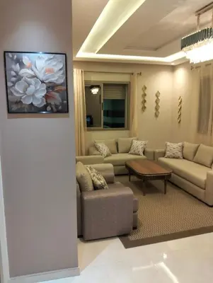 a living room with couches and a painting on the wall at NEW Luxury & Equipped Dalia , 2 bedrooms living room in Tiflet