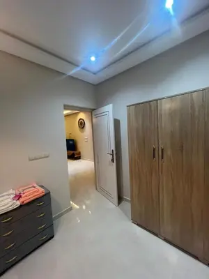 a room with a closet and a dresser and a door at NEW Luxury & Equipped Dalia , 2 bedrooms living room in Tiflet