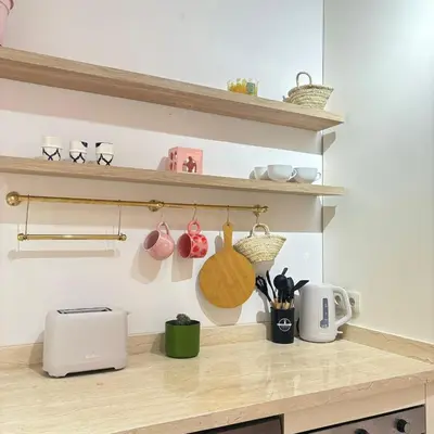 a kitchen counter with utensils on a shelf at Warm & Stylish Boho Condo - 6 km to Old Medina in Fès