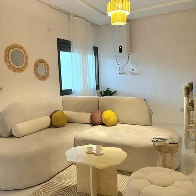 a living room with a couch and a table at Warm & Stylish Boho Condo - 6 km to Old Medina in Fès