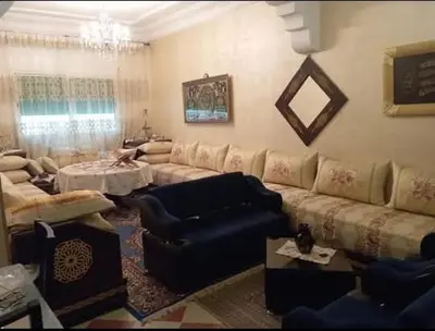 a living room with a couch and a table at Maison zakaria in Meknès