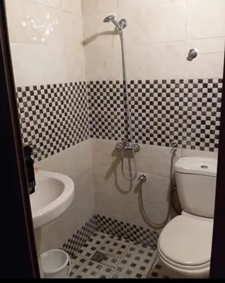 a bathroom with a shower with a toilet and a sink at Maison zakaria in Meknès