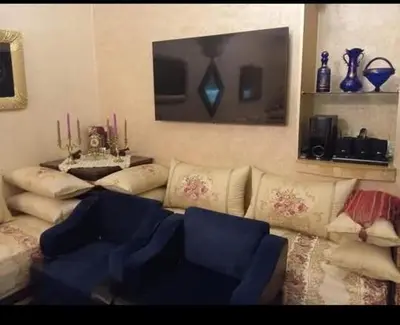 a living room with a couch and a tv at Maison zakaria in Meknès
