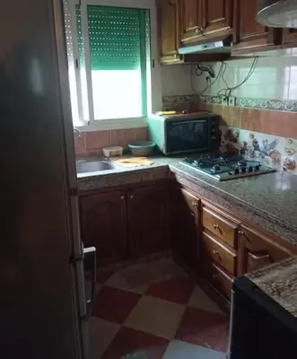 a kitchen with a sink and a stove top oven at Maison zakaria in Meknès
