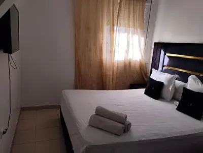 a bedroom with a bed with two towels on it at Dar Yasmine 3 in Ifrane