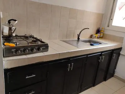 a kitchen counter with a stove and a sink at Dar Yasmine 3 in Ifrane