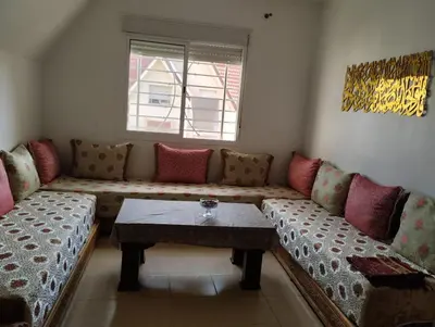 a living room with a couch and a table at Dar Yasmine 3 in Ifrane
