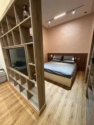 a bedroom with a bunk bed with wooden shelves at Dunes d or Stay in Er Rachidia