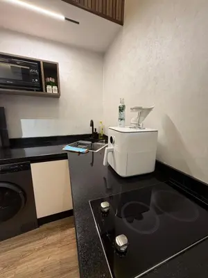 a kitchen with a sink and a mixer on a counter at Dunes d or Stay in Er Rachidia