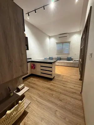 a large living room with a couch and a table at Dunes d or Stay in Er Rachidia