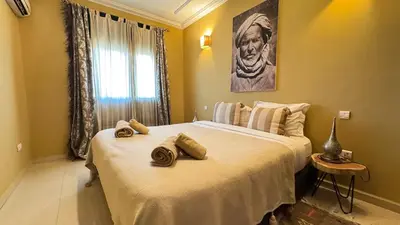 a bedroom with a large bed with towels on it at Rooftop au centre de Guéliz in Oulad Akkou