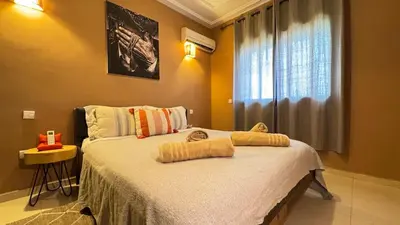 a bedroom with a bed with towels on it at Rooftop au centre de Guéliz in Oulad Akkou