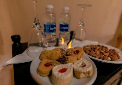 a table with two plates of pastries and bottles of water at Sunny Luxury Camp in Merzouga