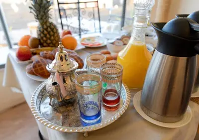 a table topped with a tray of food and drinks at Sunny Luxury Camp in Merzouga