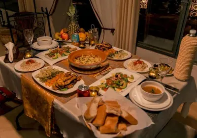 a table with plates of food on it at Sunny Luxury Camp in Merzouga