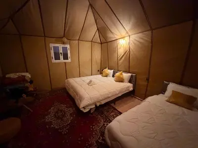 a room with two beds in a tent at Chams Luxury Camp in Lac Yasmins
