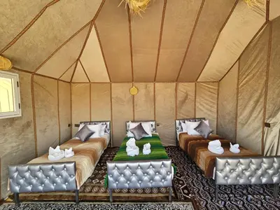 a room with two beds in a tent at Chams Luxury Camp in Lac Yasmins