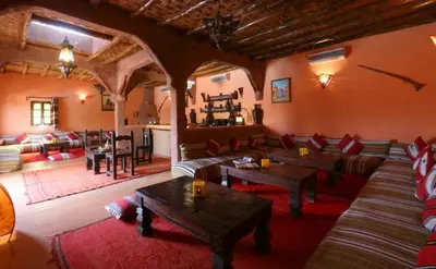 a living room with a couch and tables in a room at Riad Souiguia in Oulad Zbir
