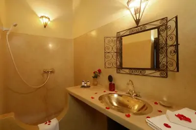 a bathroom with a sink and a mirror on the wall at Riad Souiguia in Oulad Zbir