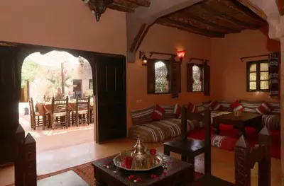 a living room with a couch and a table at Riad Souiguia in Oulad Zbir