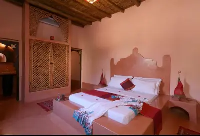 a bedroom with a large bed in a room at Riad Souiguia in Oulad Zbir