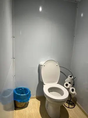a bathroom with a toilet and two rolls of toilet paper at Desert Luxe Camp in Merzouga