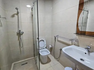 a bathroom with a shower and a toilet and a sink at Dar Jawhara in Oulad Akkou