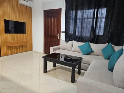 a living room with a couch and a coffee table at Dar Jawhara in Oulad Akkou