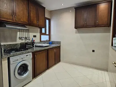 a kitchen with a washer and a washing machine at Dar Jawhara in Oulad Akkou