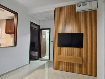 a television on a wooden wall in a room at Dar Jawhara in Oulad Akkou