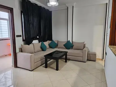 a living room with a couch and a table at Dar Jawhara in Oulad Akkou