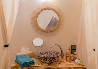 a bathroom with a sink and a mirror at Dunes Light Luxury camp in Merzouga