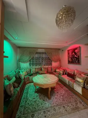 a living room with a couch and a table at Lamoulian stay in Fès
